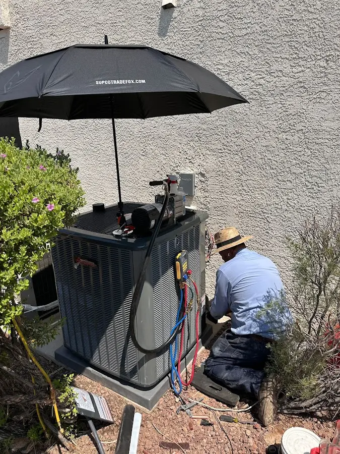 HVAC technician performing outdoor AC maintenance in Pembroke Pines